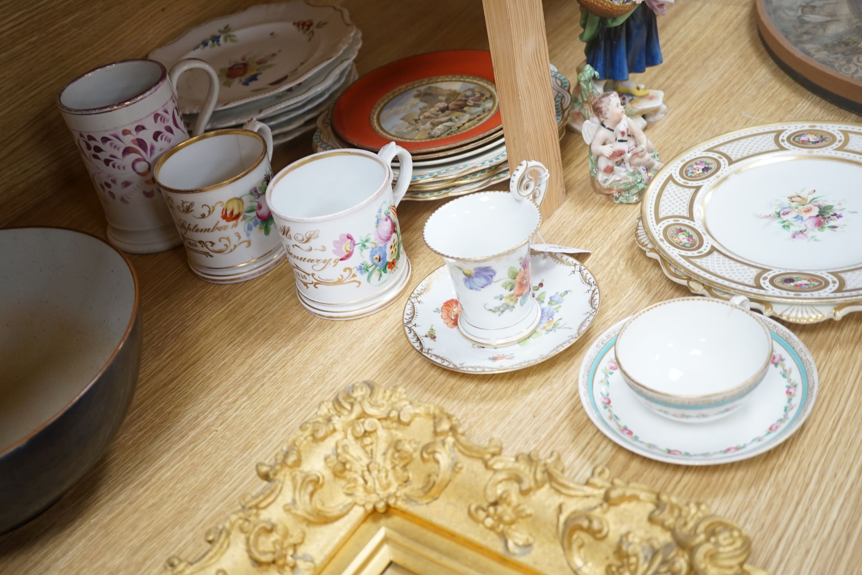 A collection of 19th century English porcelain plates and mugs and a Derby Cupid group, c.1775